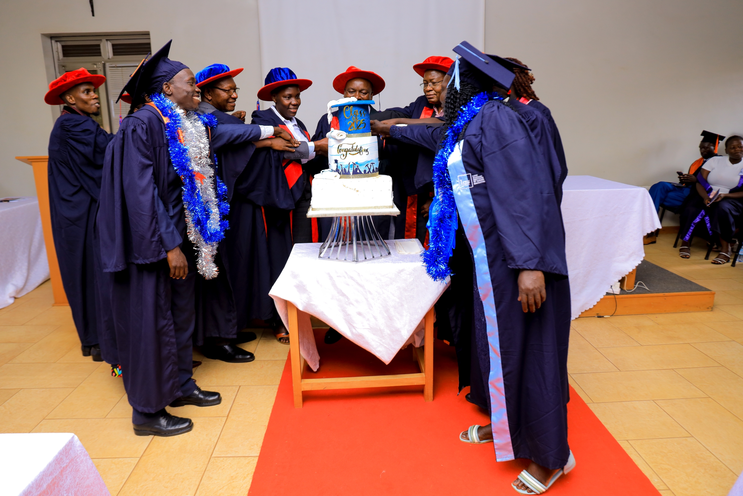 Cutting cake to mark the milestone of the 6th graduation at LGIHE